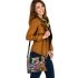 An intricate colorful painting shoulder handbag