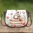 Baby rabbit sitting on top of books surrounded by flowers saddle bag