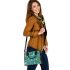 Butterflies and flowers scattered across shoulder handbag