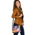 Colored butterfly surrounded by vibrant flowers shoulder handbag