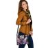 Colored butterfly surrounded by vibrant flowers shoulder handbag