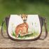 Cute baby deer sitting in the grass saddle bag