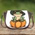 Cute cartoon frog wearing a witch's hat sitting on a pumpkin saddle bag