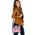 Cute pink owl with a bow on its head surrounded by candy shoulder handbag