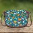 Flowers and butterflies in shades of orange saddle bag