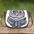 Grey owl with big eyes wearing glasses and graduation hat holding saddle bag