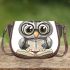 Grey owl with big eyes wearing glasses and graduation hat holding saddle bag