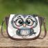Grey owl with big eyes wearing glasses and graduation hat holding saddle bag
