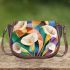 Painting of calla lilies in geometric shapes and forms saddle bag
