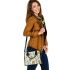 Pattern of owls perched on tree branches shoulder handbag