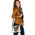 Queen bee with a crown sitting on flower shoulder handbag