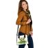 Smiling frog sitting on a pond shoulder handbag