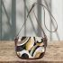 Abstract composition of circles and lines in black saddle bag