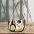 Abstract composition of circles and lines in gold saddle bag