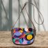 Abstract composition with geometric shapes and vibrant colors saddle bag