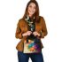 Abstract painting of circles and spheres shoulder handbag