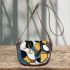 Abstract painting of guitar shapes and lines in blues saddle bag