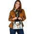 Adorable fawn standing in the snow shoulder handbag