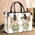 Adorable two bunnies holding hands dressed in green small handbag