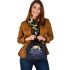 An owl perched on a branch during moonlit night shoulder handbag