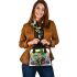 Cartoon tree frog sitting on top of an irish mushroom shoulder handbag