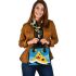 Circles and triangles in a blue sky shoulder handbag
