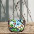 Colorful frogs hanging from tree branches in the jungle saddle bag
