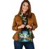 Colorful frogs hanging from tree branches in the jungle shoulder handbag