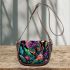 Colorful glowing butterfly surrounded by flowers and leaves saddle bag