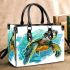 Cute baby turtle in the ocean small handbag