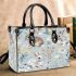 Cute bunnies and flowers on light blue small handbag