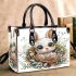 Cute cartoon baby bunny with big eyes sitting small handbag