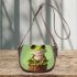 Cute cartoon frog sitting on a tree stump with big eyes saddle bag