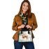 Cute deer standing in the snow shoulder handbag