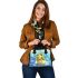 Cute frog wearing a crown sitting on golden ball shoulder handbag