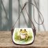 Cute happy frog in the grass near water saddle bag