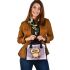 Cute owl cartoon surrounded in the style of stars and flowers shoulder handbag