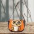 Cute owl with big eyes holding a white coffee cup saddle bag