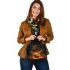 Deer with antlers standing in front of trees shoulder handbag