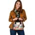 Elegant deer standing amidst autumn foliage shoulder handbag