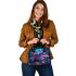 Frog sitting on colorful mushrooms in the forest shoulder handbag