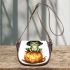 Frog wearing a black witch's hat sitting on top of a halloween pumpkin saddle bag