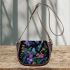 Glowing butterflies dance among vibrant flowers saddle bag