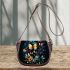 Glowing butterflies dance among vibrant flowers saddle bag