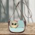 Owl peeking over the edge wearing a bow on its head saddle bag