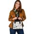 Pattern of owls perched on tree branches shoulder handbag