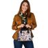 Pattern of owls perched on tree branches shoulder handbag