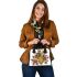 Queen bee sitting on top of honeycomb shoulder handbag