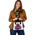 Queen bee with a crown sitting on flower shoulder handbag