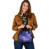 The moon and purple butterflies in the sky shoulder handbag